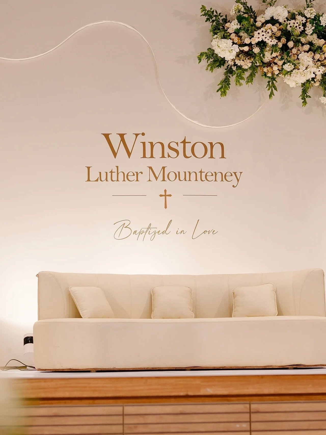 Ivory stage with white florals and gold lettering
